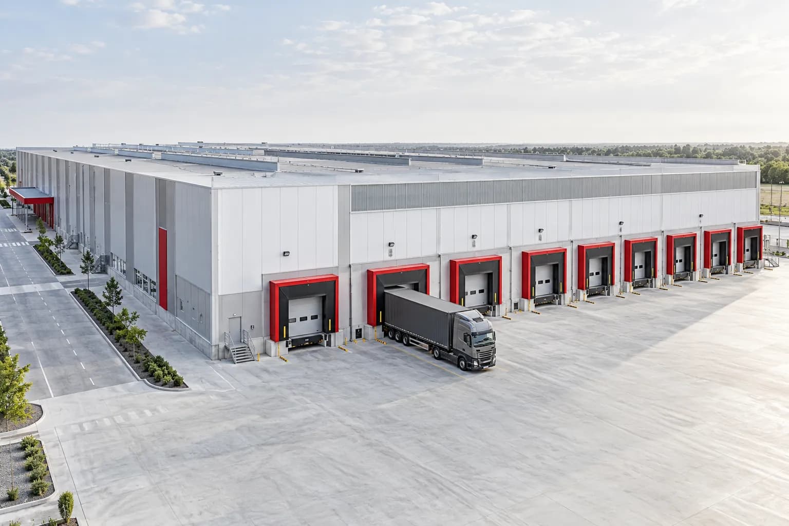 A modern completed warehouse with loading docks and a spacious truck forecourt.